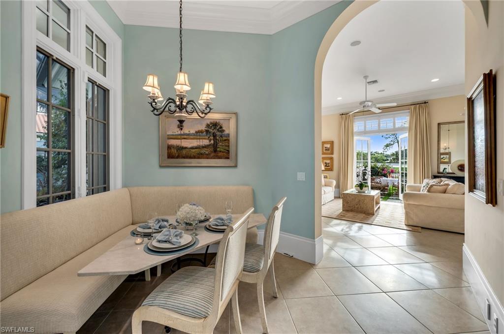 Pile in the grandkids around the banquette!  This charming home is so bright and cheerful, with beautiful, private views to the courtyard pool and the 18th hole.