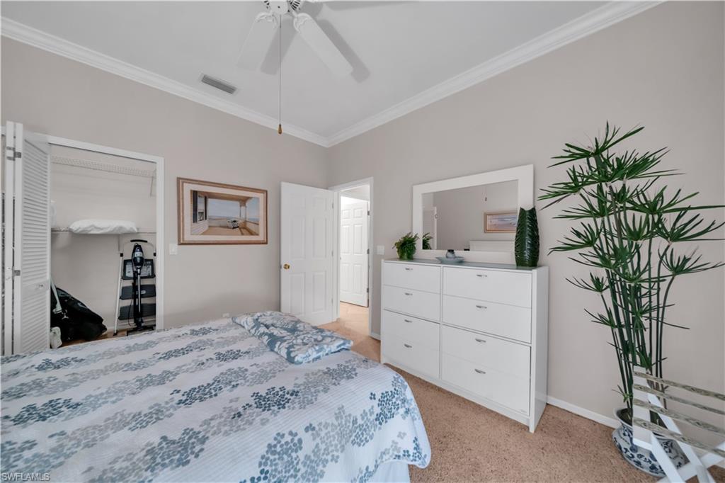 Bedroom featuring crown molding, light carpet, and ceiling fan