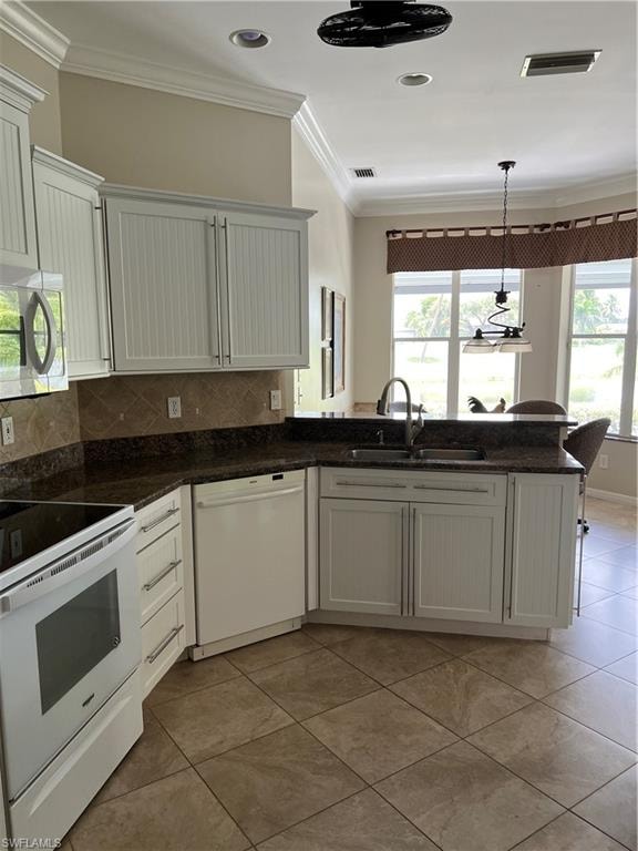 White cabinetry with beadboard paneling, stone countertops, and a tile backsplash