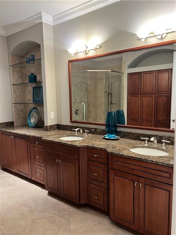 Luxurious master bathroom featuring an extended double-vanity with granite countertops, rich wood-finish cabinetry, and polished nickel hardware
