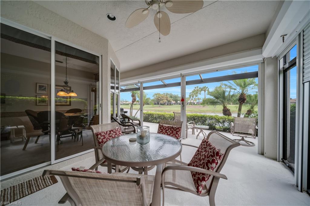 Sunroom / solarium with ceiling fan, outdoor dining area, and golf course view