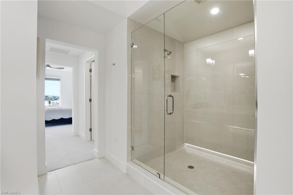 primary Ensuite bathroom with a shower stall,  tile patterned flooring, and recessed lighting - Virtually Edited Image