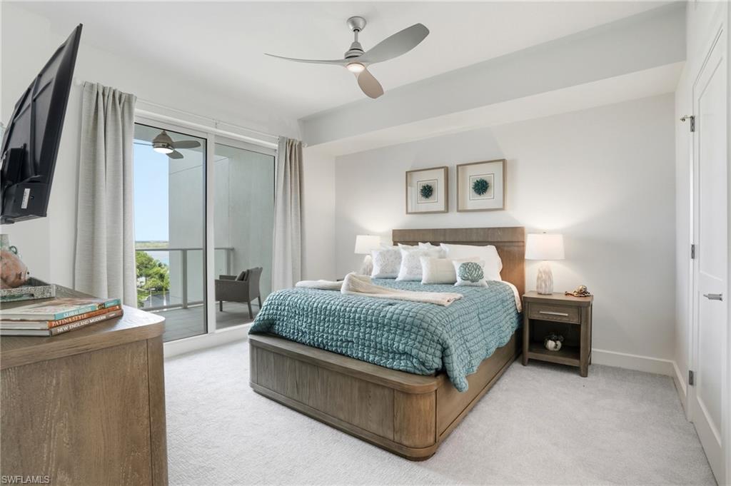 Bedroom with light carpet, access to outside, and ceiling fan - Virtually Edited Image
