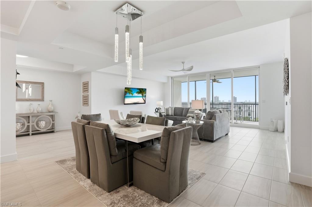 Dining area with breathtaking views of the beautiful Fort Myers beach out of your sliding  impact glass doors. Virtually edited
