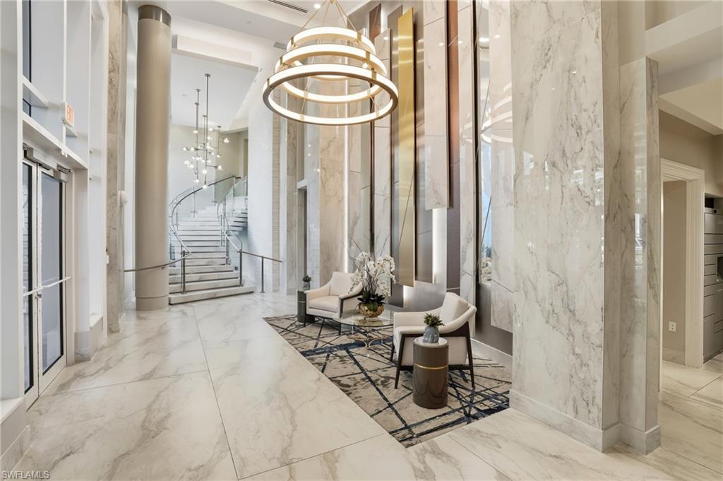 Lobby area with towering ceilings and beautifully designed stairs -Virtually edited