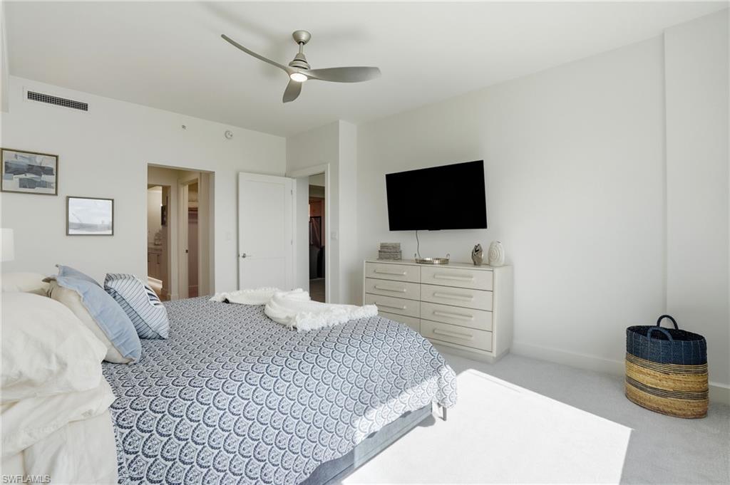 Bedroom with light colored carpet and a ceiling fan - Virtually Edited Image
