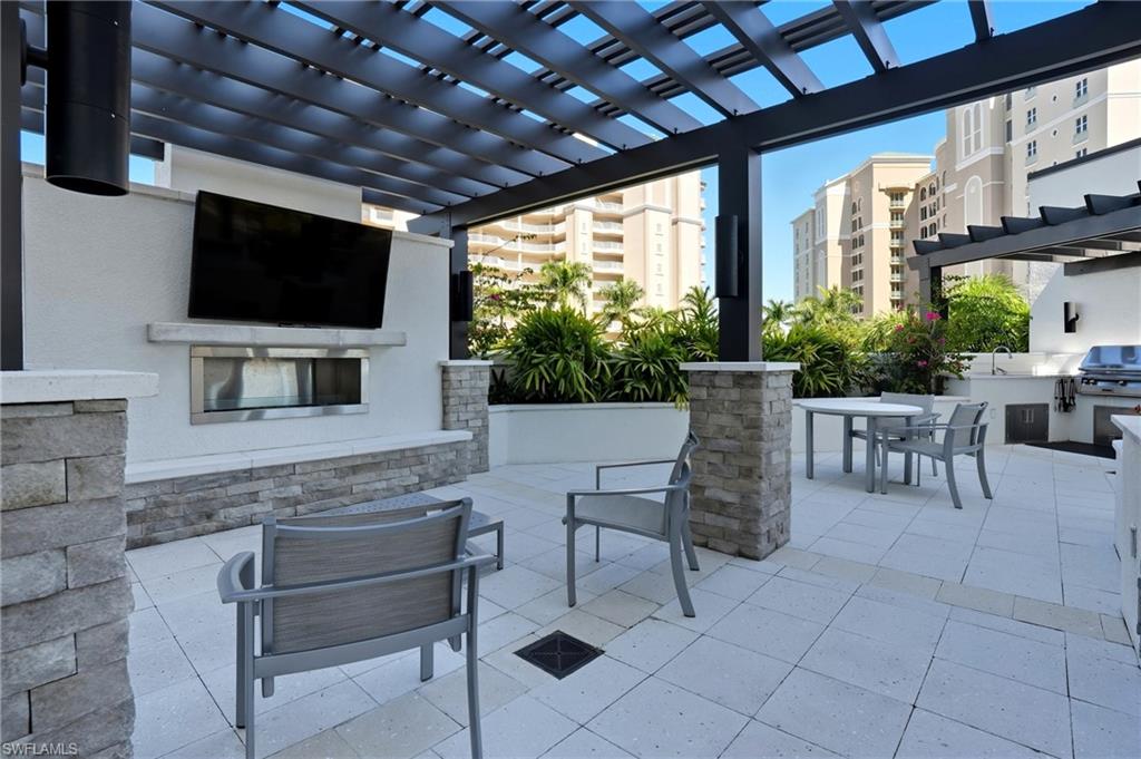 View of outdoor patio / terrace with a pergola, a grill, and outdoor dining area-Virtually Edited