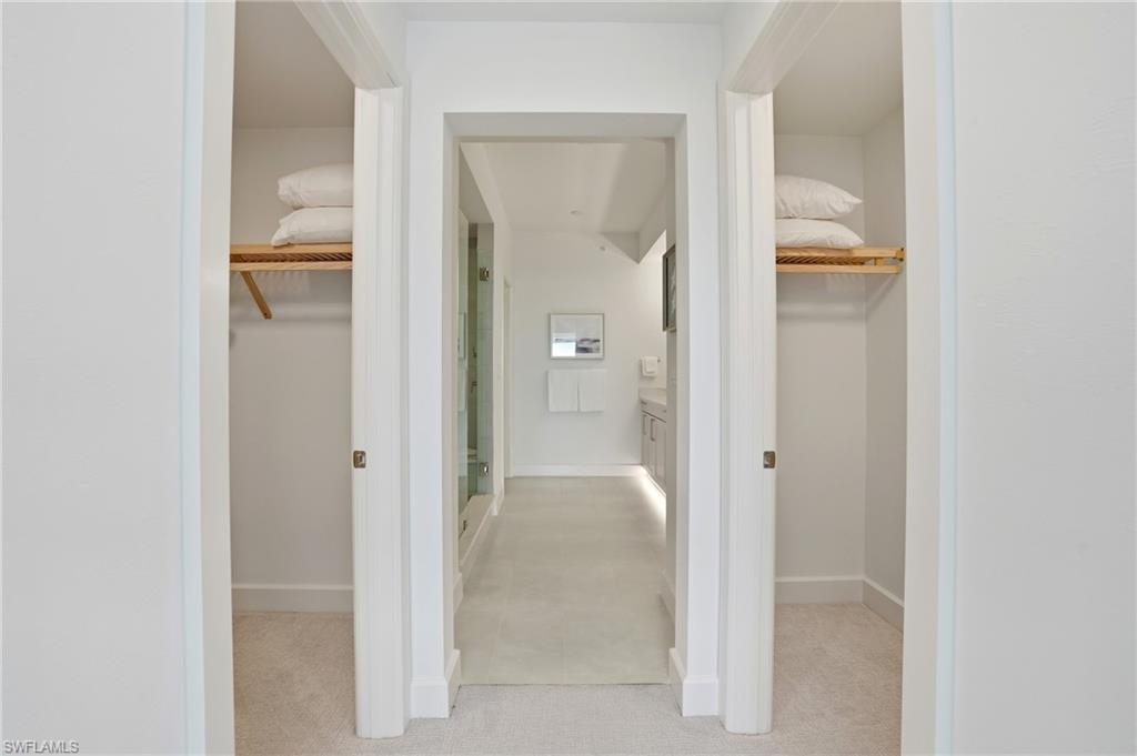 a view of both closets and primary bathroom Virtually Edited Image