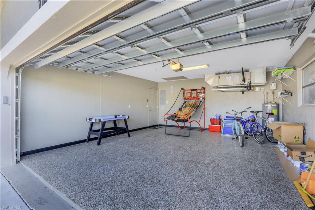 Garage with water heater and baseboards