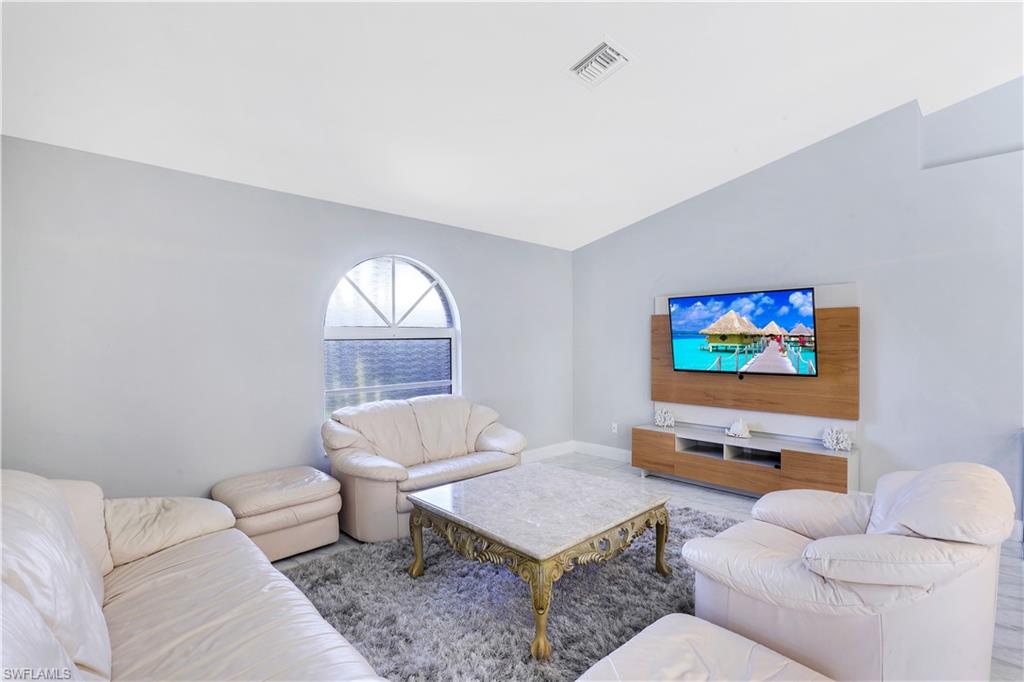 Living room featuring lofted ceiling