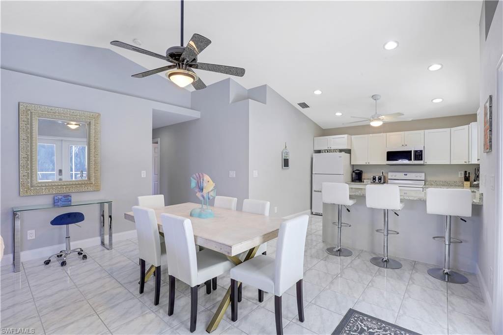 Dining room with a ceiling fan, lofted ceiling, and recessed lighting
