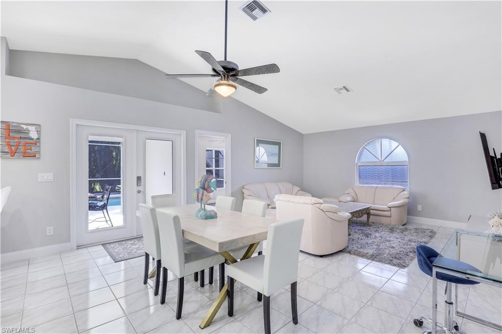 Dining area with french doors, ceiling fan, and light tile patterned flooring