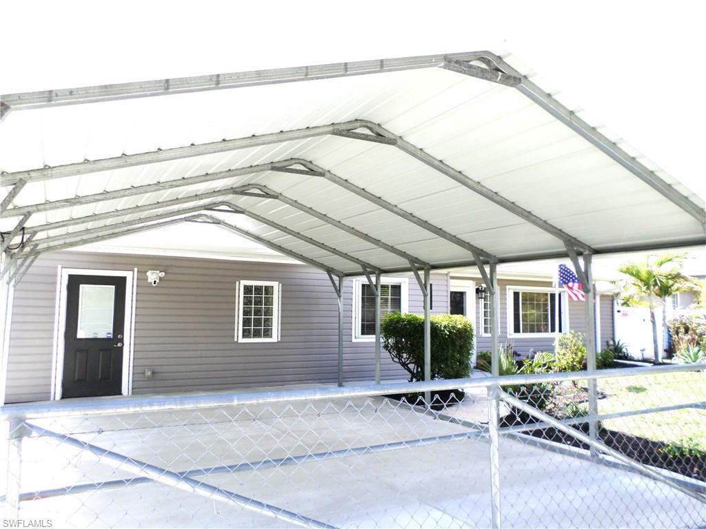 Double Over Size Attached Carport With Cement Driveway.