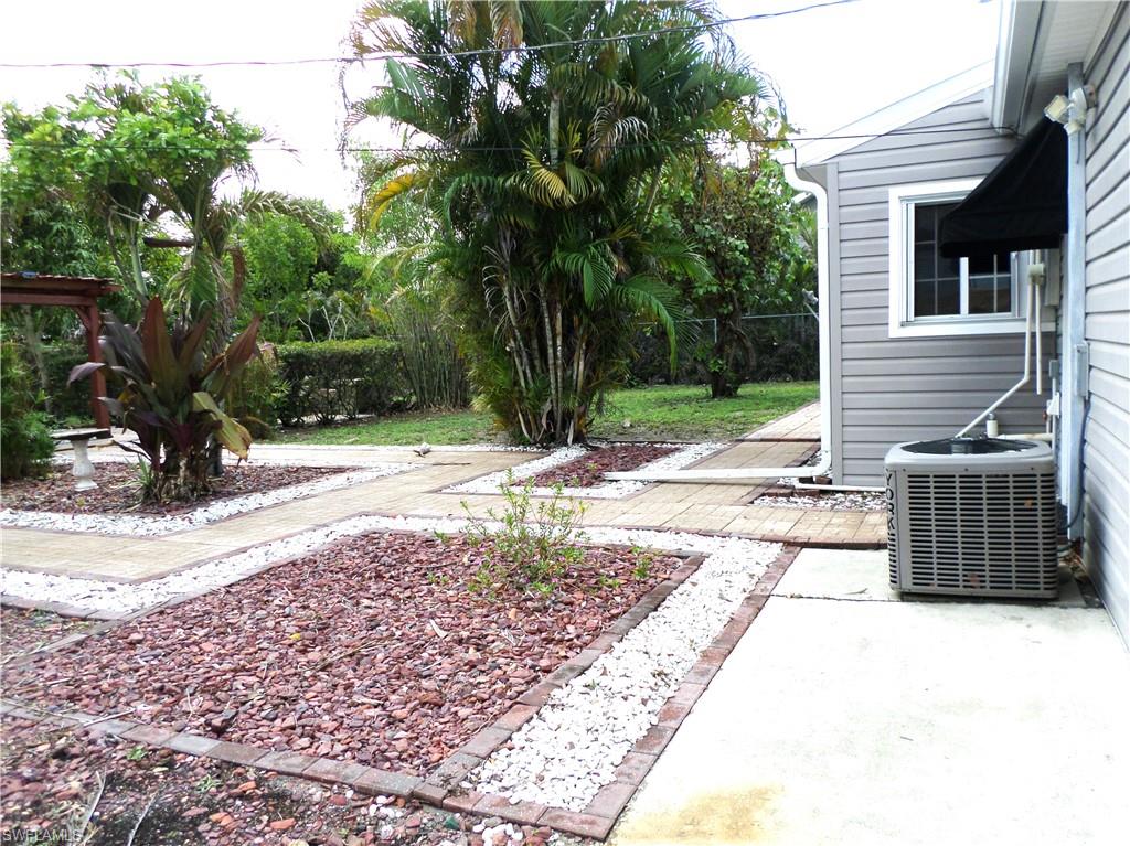 Paved & Stoned Back Courtyard With Some Grass Areas.
