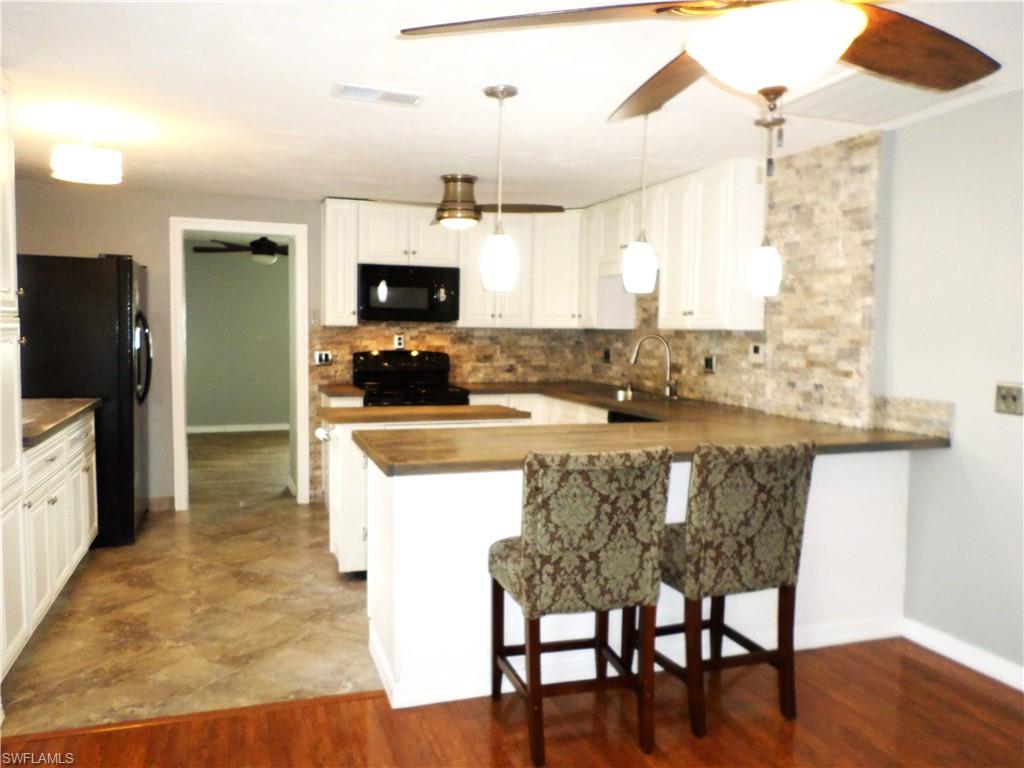 Large Open Kitchen With Island & 2 Bar Stools.