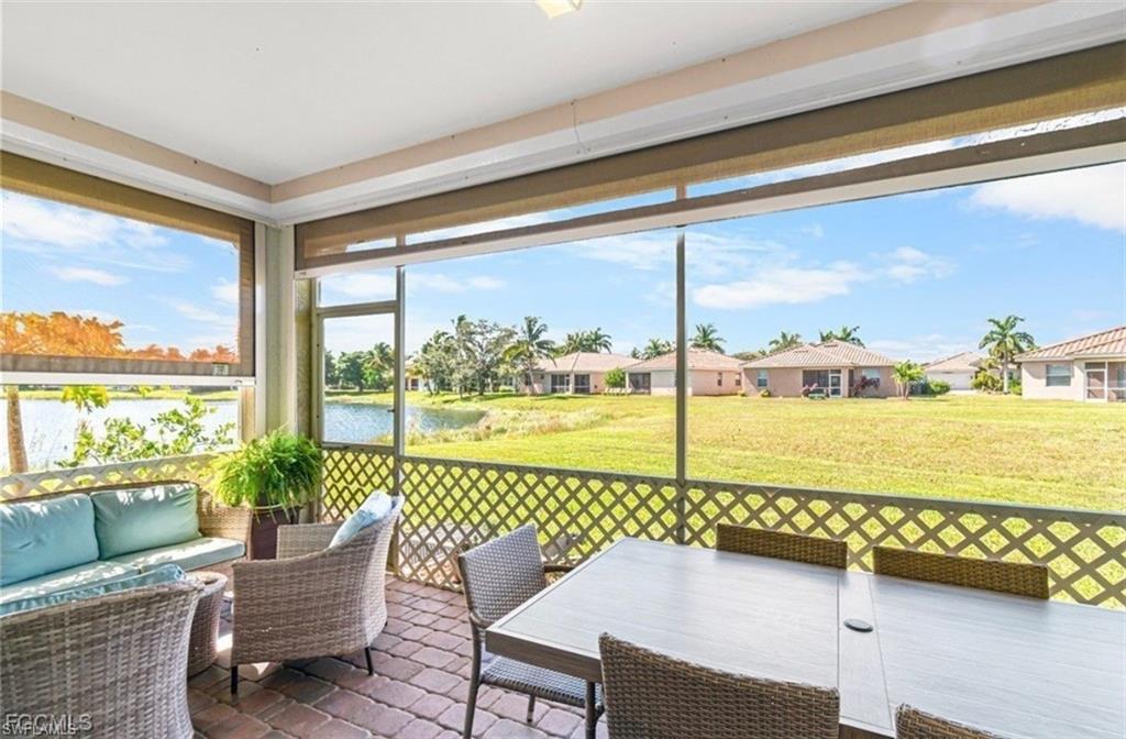 Sunroom featuring an outdoor living / dining area and a water view