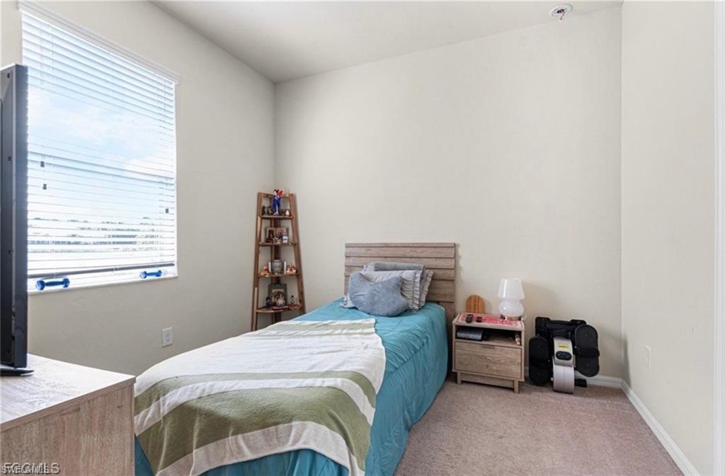 Carpeted bedroom with baseboards