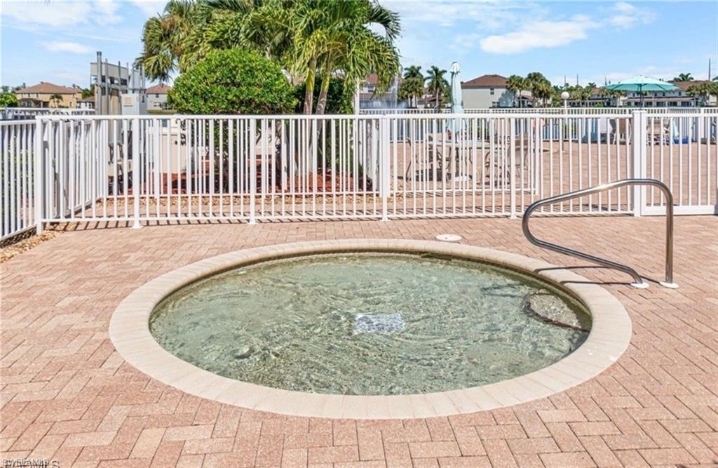 View of swimming pool with a hot tub and a residential view