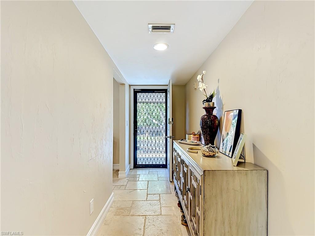 Spacious hallway leading into the home with neutral tones throughout.