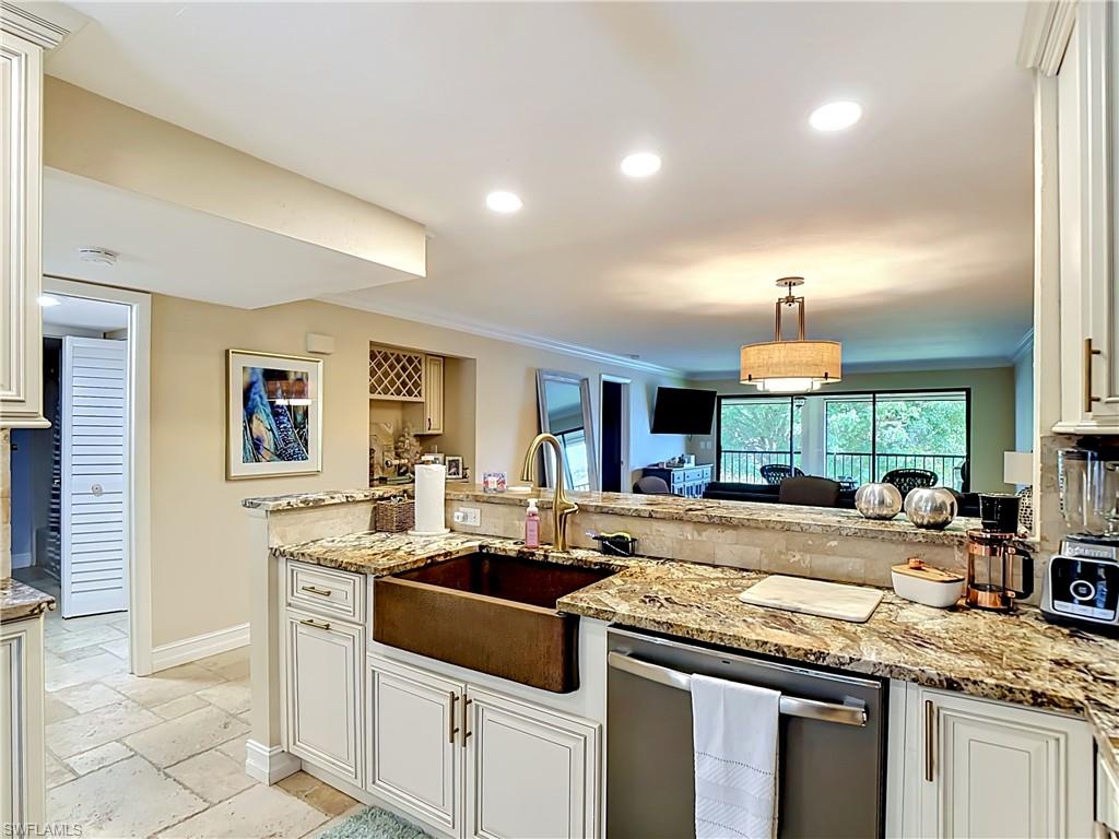Large kitchen with bar seating and seamless flow into living areas.