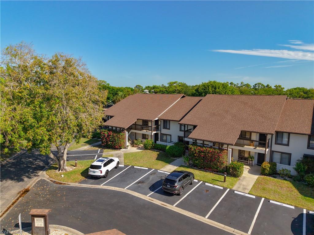Aerial perspective highlighting building layout, parking, and well-maintained grounds.