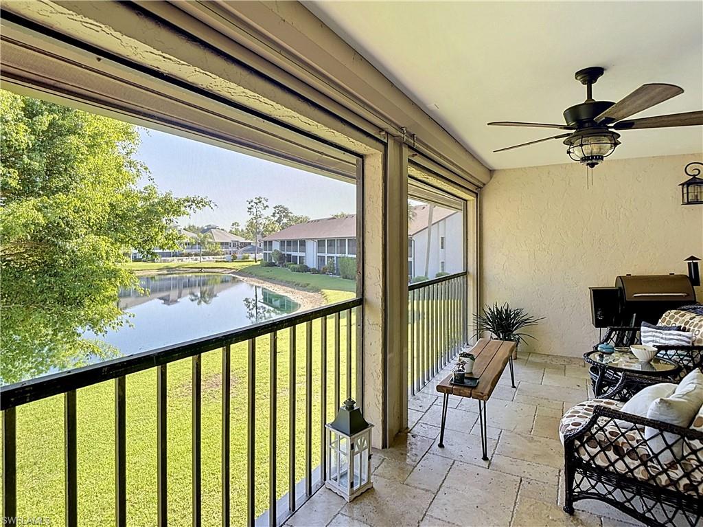 Beautiful balcony overlooking lush greenery and water.