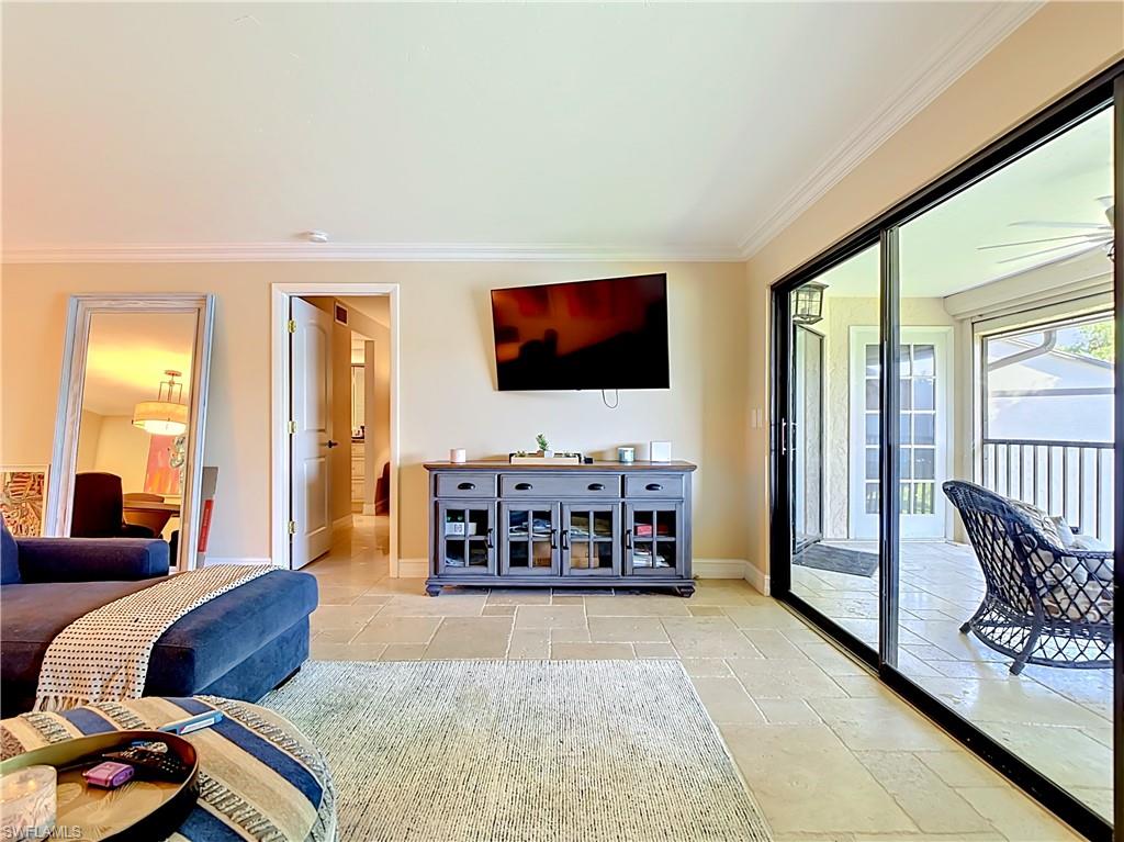 Living space with large windows and access to outdoor area.