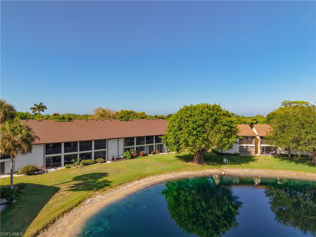Rear exterior view featuring outdoor space and water backdrop.