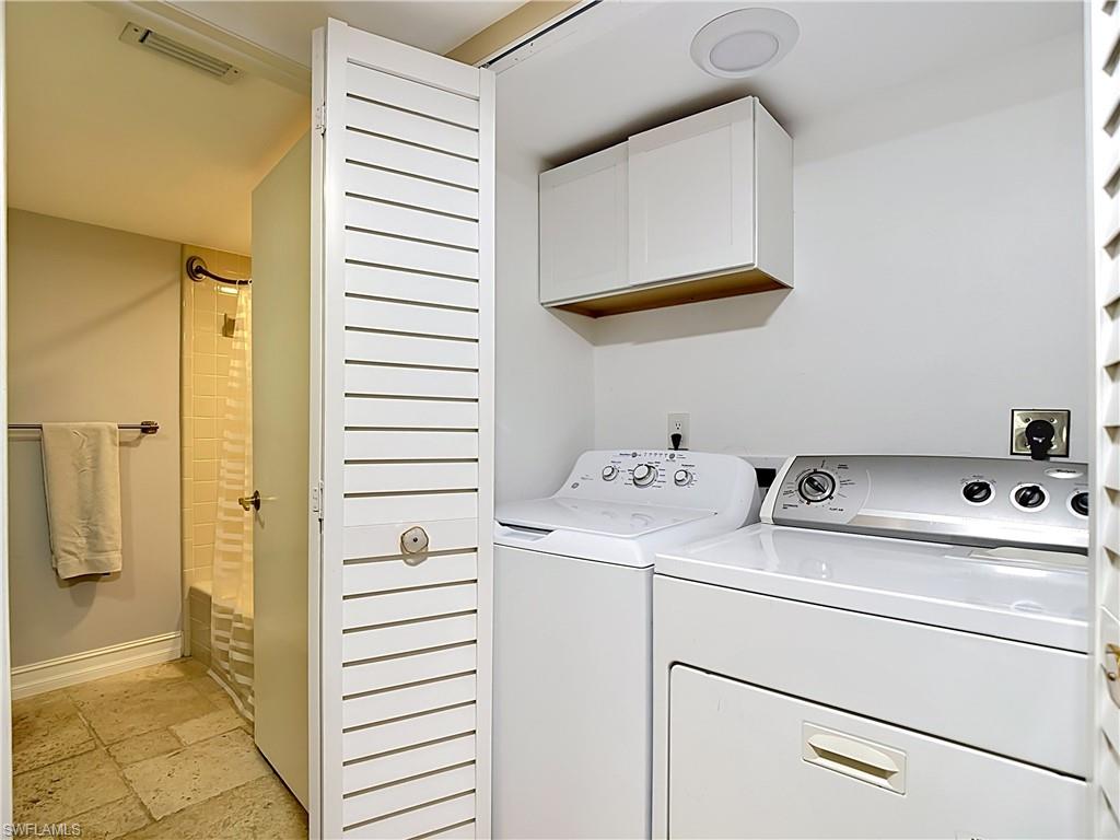 Convenient in-unit laundry area with storage space.