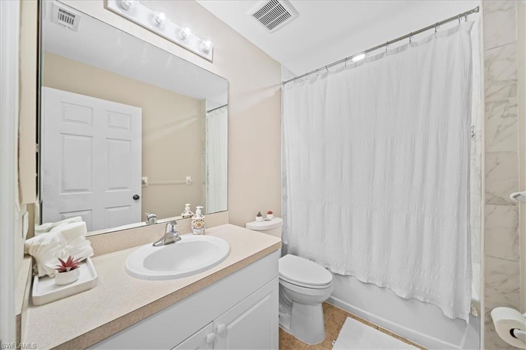 Bathroom featuring vanity and shower / bath combo