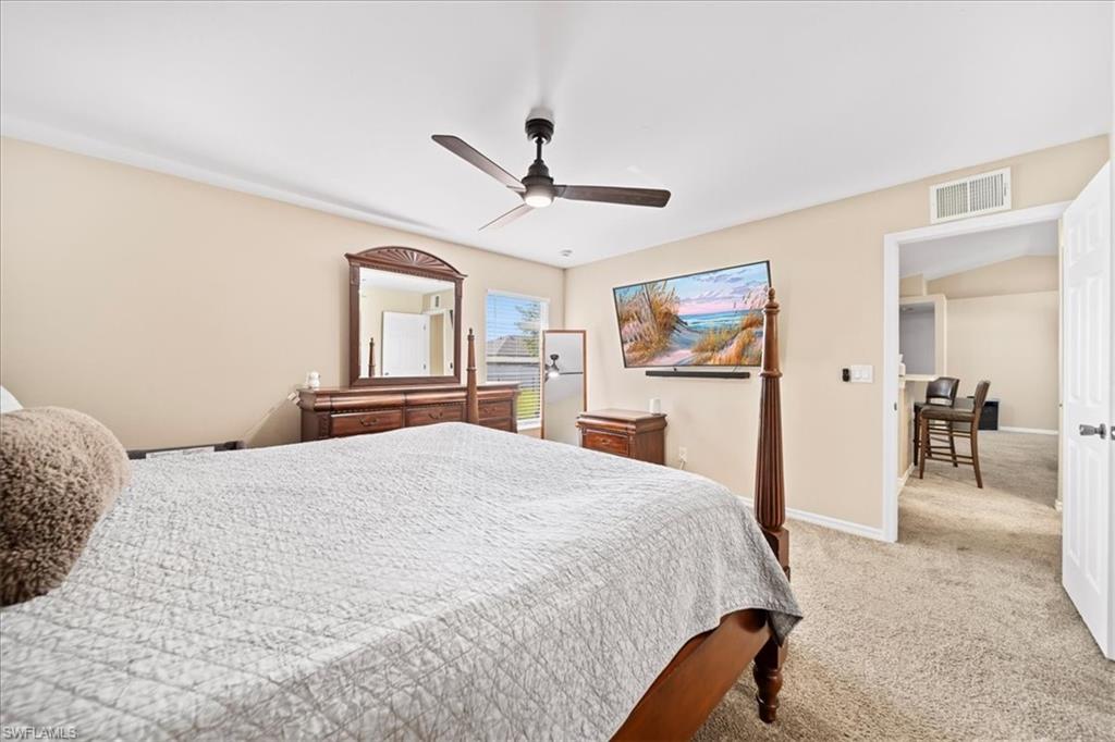 Bedroom featuring light colored carpet and a ceiling fan