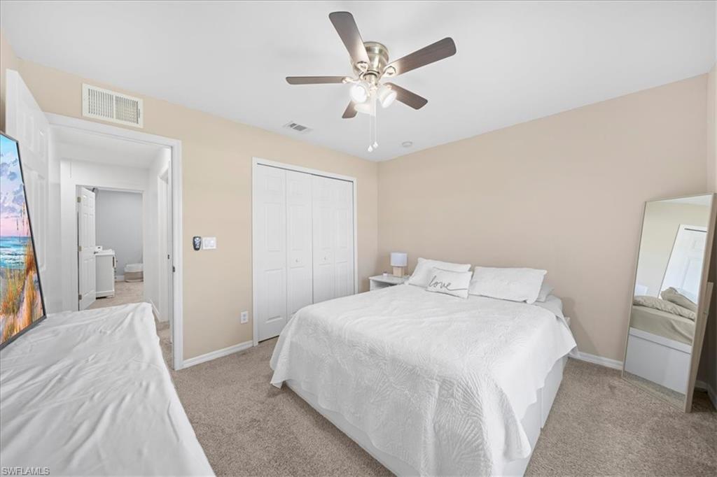 Bedroom featuring ceiling fan, a closet, and carpet