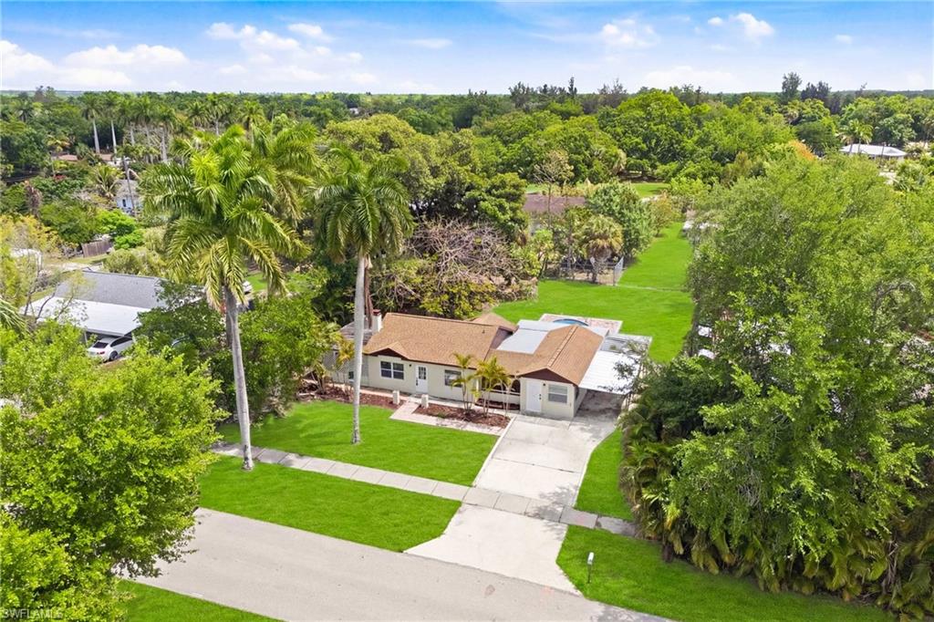 Beautiful overhead shot highlighting the front of the residence, curb appeal, and surrounding lot.