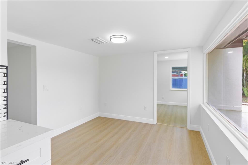 Spacious dining area showcasing a large window with scenic outdoor views, perfect for enjoying meals in a bright, open setting.
