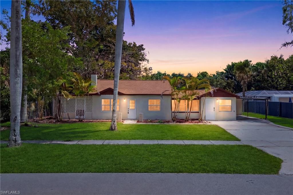 Beautifully captured front exterior featuring glowing sunset skies behind the home, creating a dramatic and inviting scene.