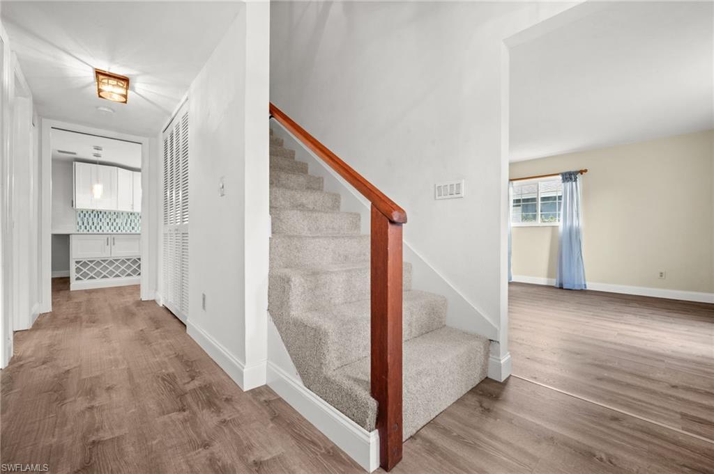 Entryway with Stairs to guest bedrooms. Living Room on the Right, Kitchen and Family room straight back