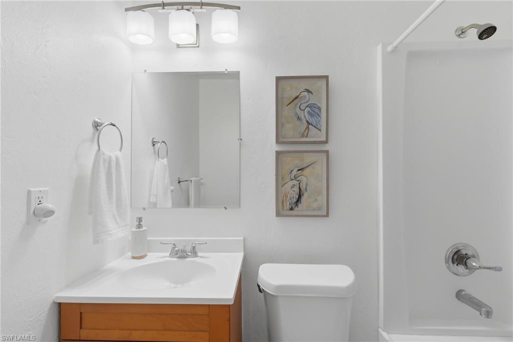 Full bath with vanity and shower / washtub combination