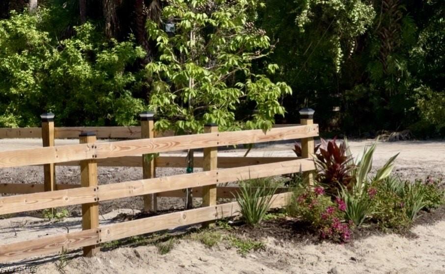 Wood-finish split rail fencing featuring post-top lighting