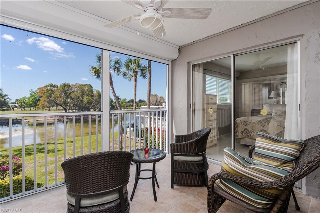 Sunroom featuring a water view and ceiling fan