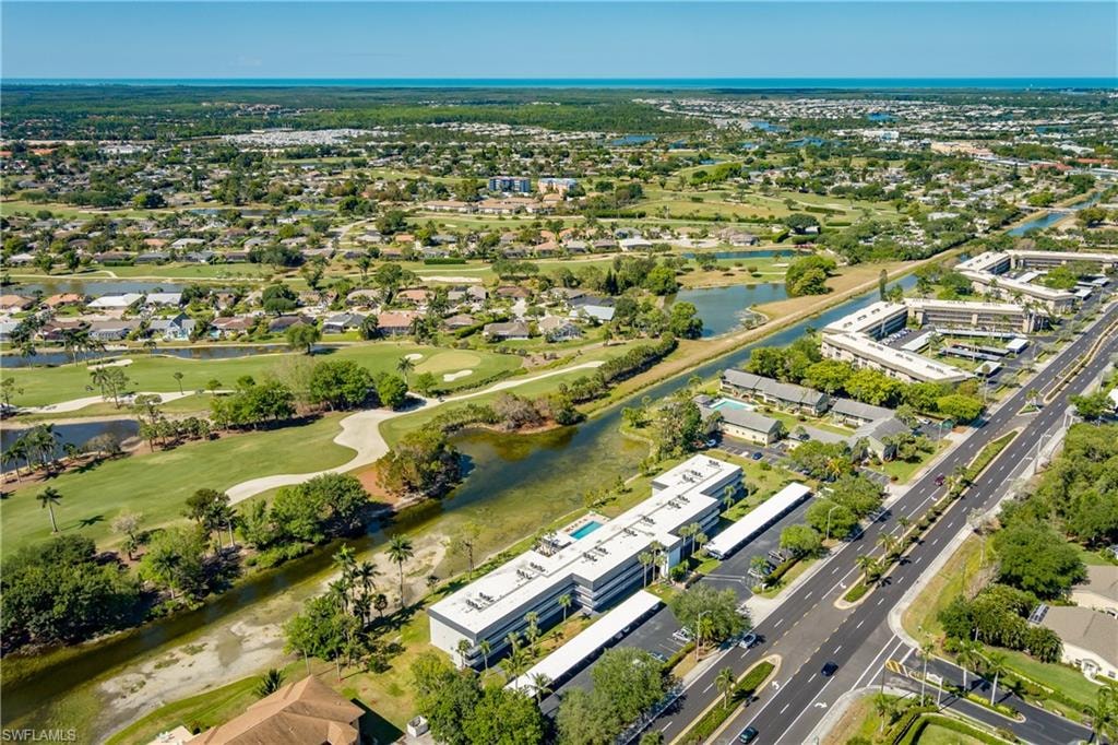 Bird's eye view with view of golf course and a water view