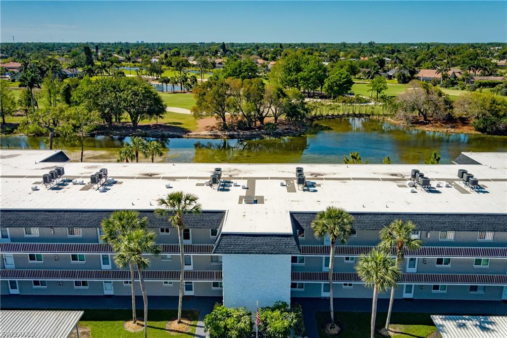 Bird's eye view with view of golf course and a water view