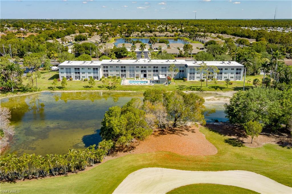 Drone / aerial view with view of golf course and a water view
