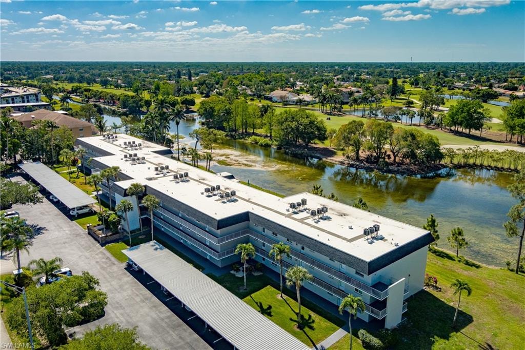 Birds eye view of property with a water view