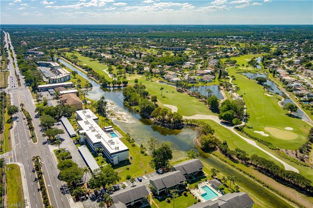 Birds eye view of property featuring view of golf course and a water view