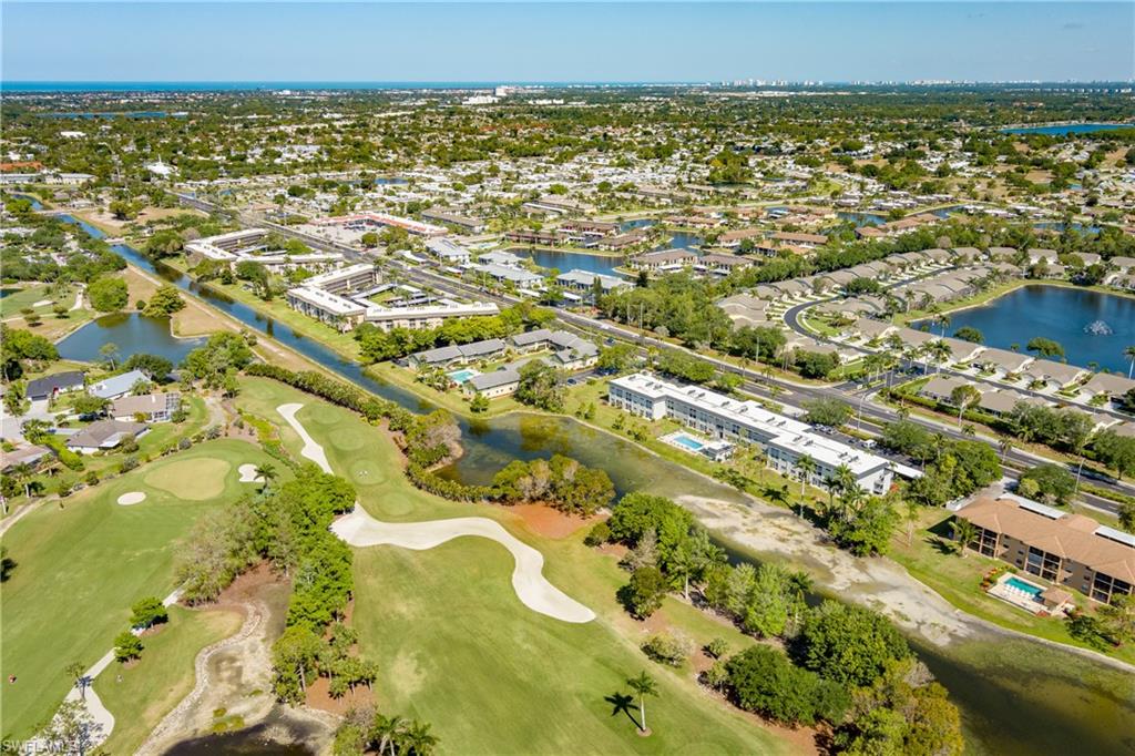 Birds eye view of property featuring a residential view, a water view, and view of golf course