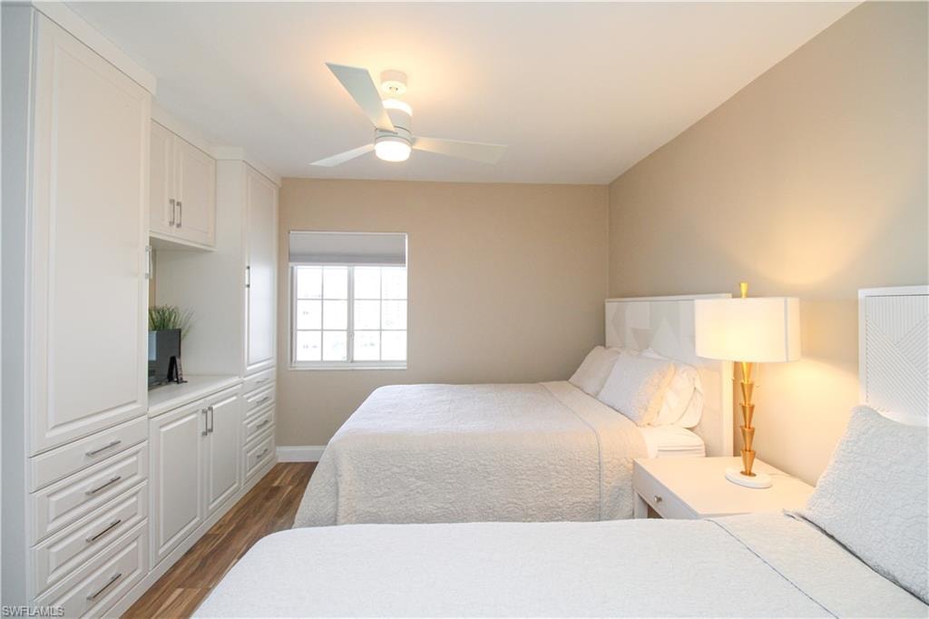 Bedroom featuring dark wood-type flooring and ceiling fan