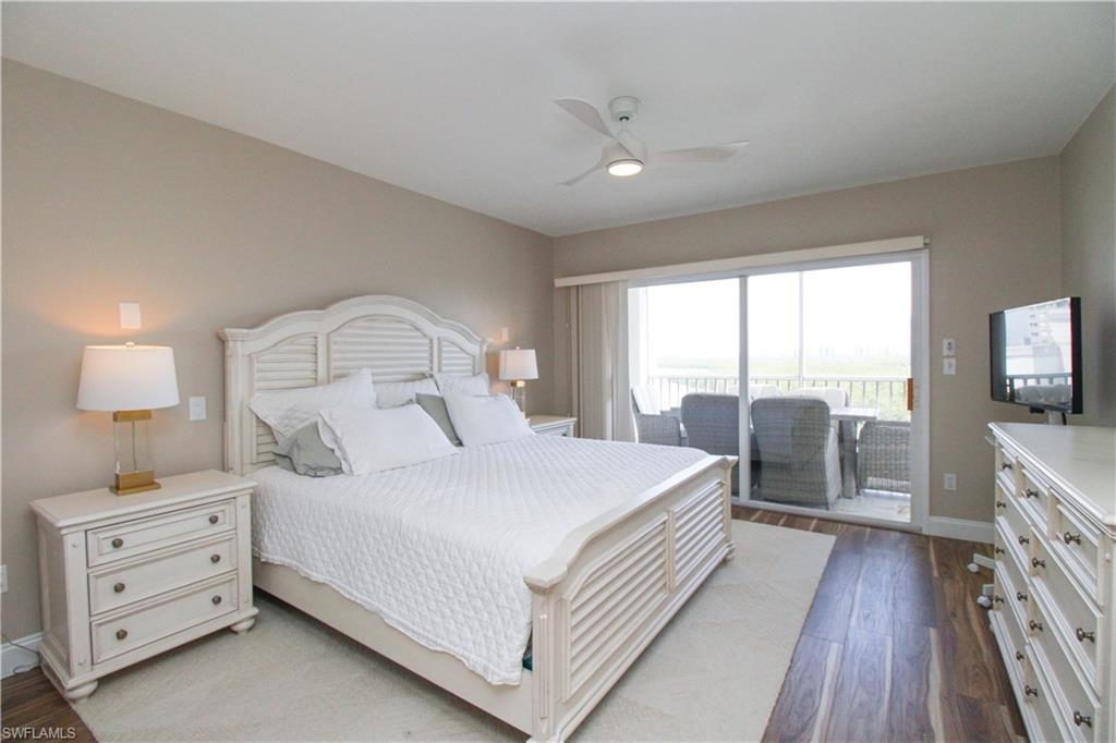 Bedroom with light hardwood / wood-style floors, access to outside, and ceiling fan