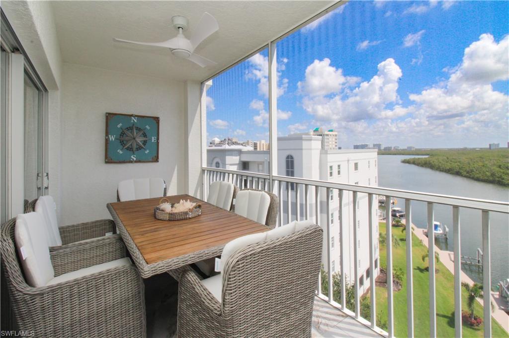 Balcony with a water view and ceiling fan