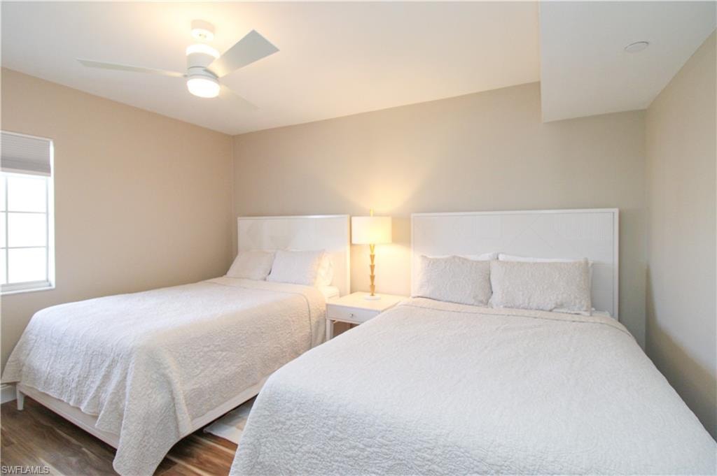 Bedroom featuring ceiling fan and dark hardwood / wood-style flooring