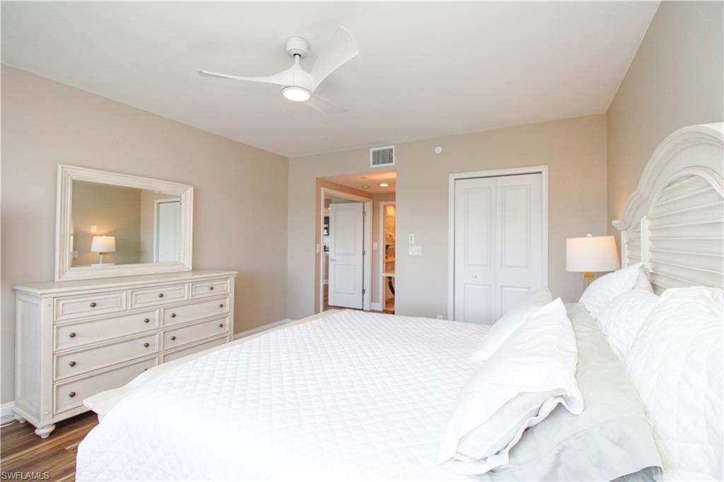 Bedroom featuring a closet, ceiling fan, and dark hardwood / wood-style flooring